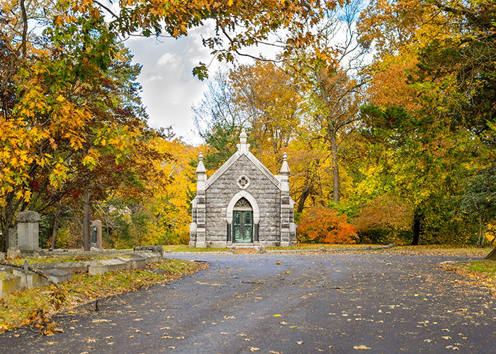 small, abandoned church surrounded by colorful autumn foliage